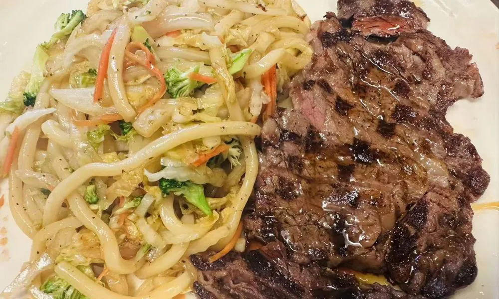Grilled steak served with stir-fried udon noodles at 168 Sushi & Kitchen, a Sushi Restaurant in Fairhaven.