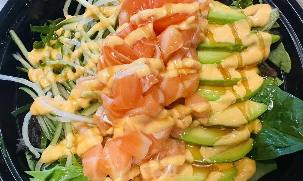 Salmon avocado salad with spicy sauce on mixed greens at 168 Sushi & Kitchen, a Sushi Restaurant in Fairhaven.